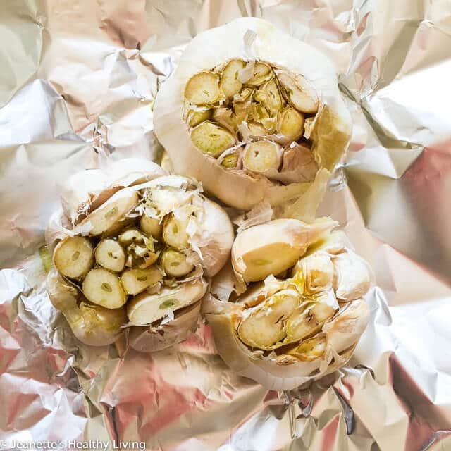 Learn how to roast garlic. It's easy to make and serves as a flavor booster in dips, sauces, soups, mashed potatoes and more ~ https://jeanetteshealthyliving.com