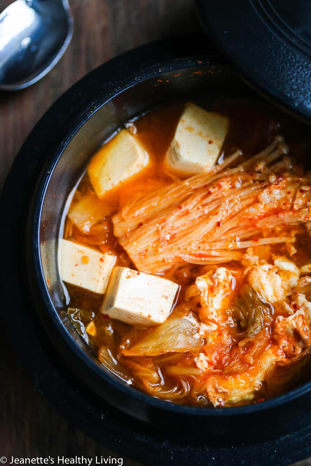 Spicy Kimchi Tofu Mushroom Egg Soup - great way to warm up your belly on a cold winter day. Korean kimchi and gochujang spice up this vegetarian soup, and tofu and egg provide the proteins.