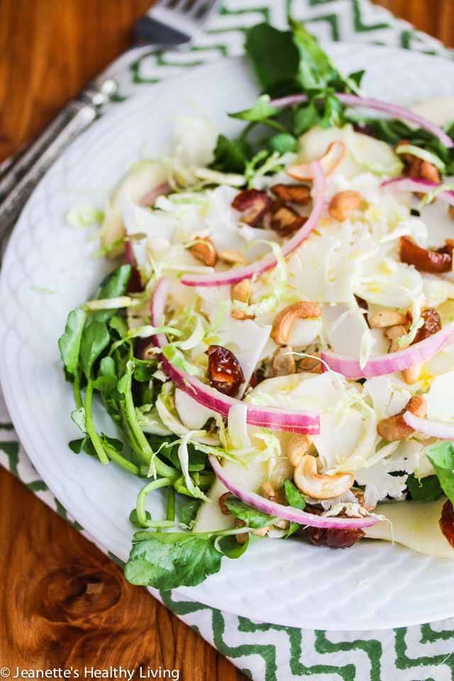 Shaved Cauliflower Brussels Sprout Pear Salad with Watercress Medjool Dates and Cashews - crunchy, juicy and sweet, this healthy salad is drizzled with a honey balsamic flax seed oil dressing