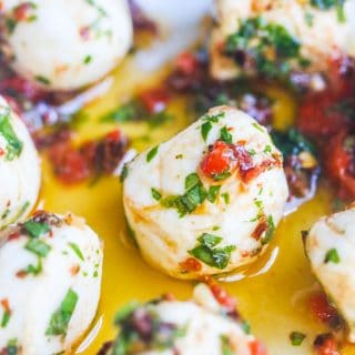 Marinated Mozzarella Balls - skewer with cherry tomatoes for a party appetizer - always a party favorite - super easy and delicious